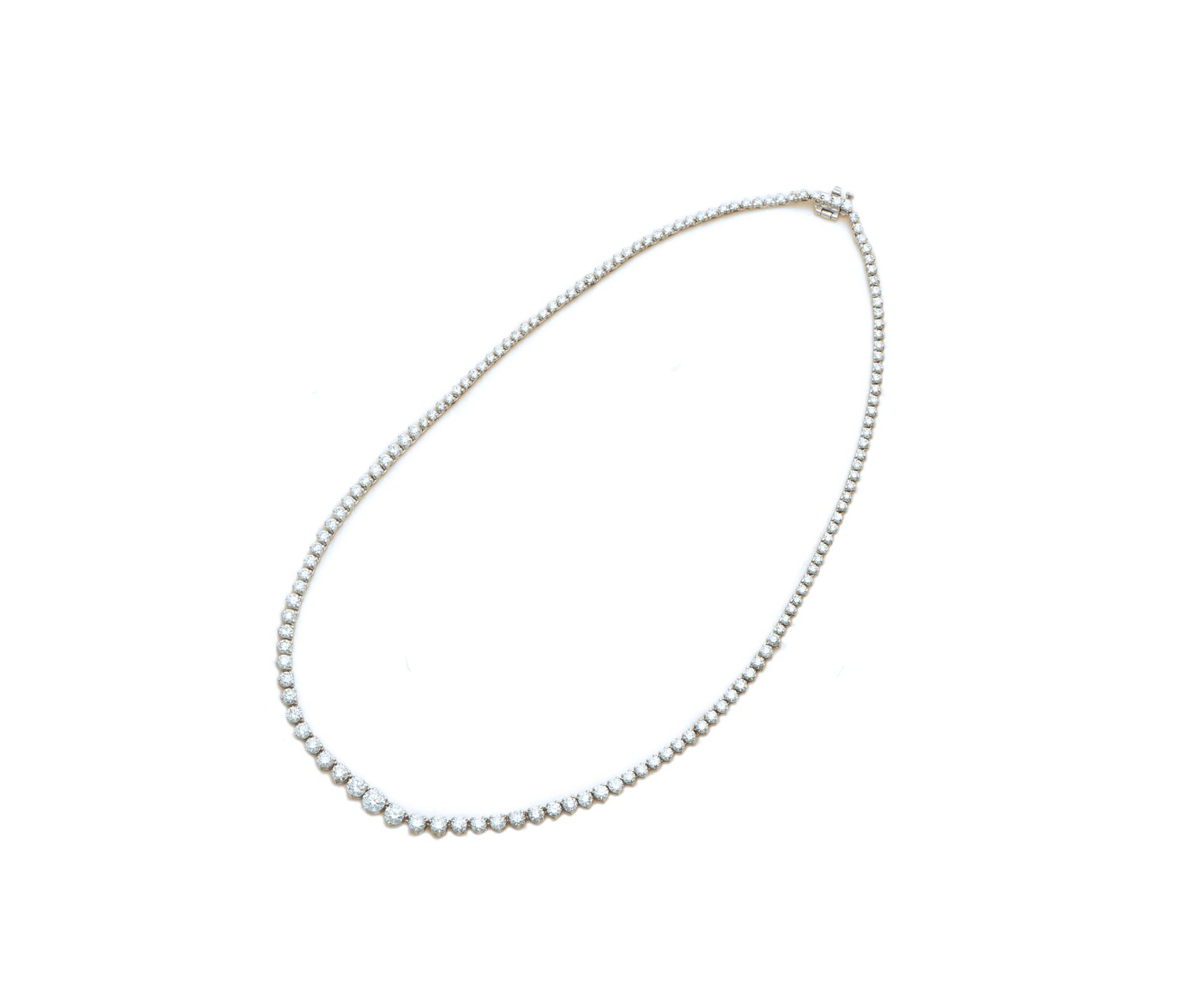 A graduated diamond line necklace in white gold