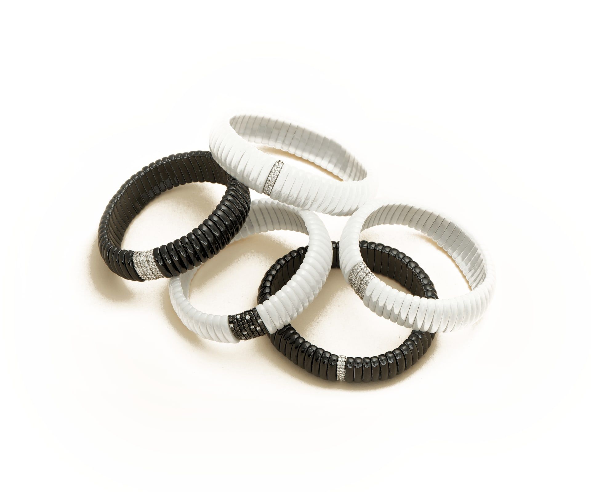 Black and white enamel stretch bracelets with gold accents