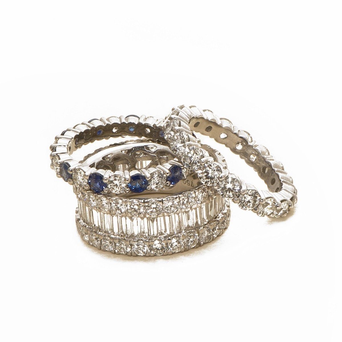 A stack of diamond and sapphire eternity bands