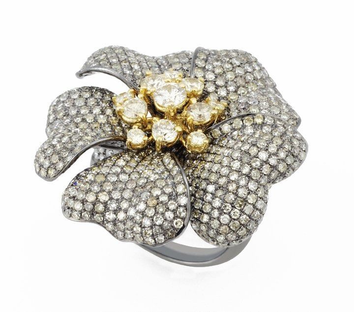 A pavé diamond flower cocktail ring with yellow diamond centres