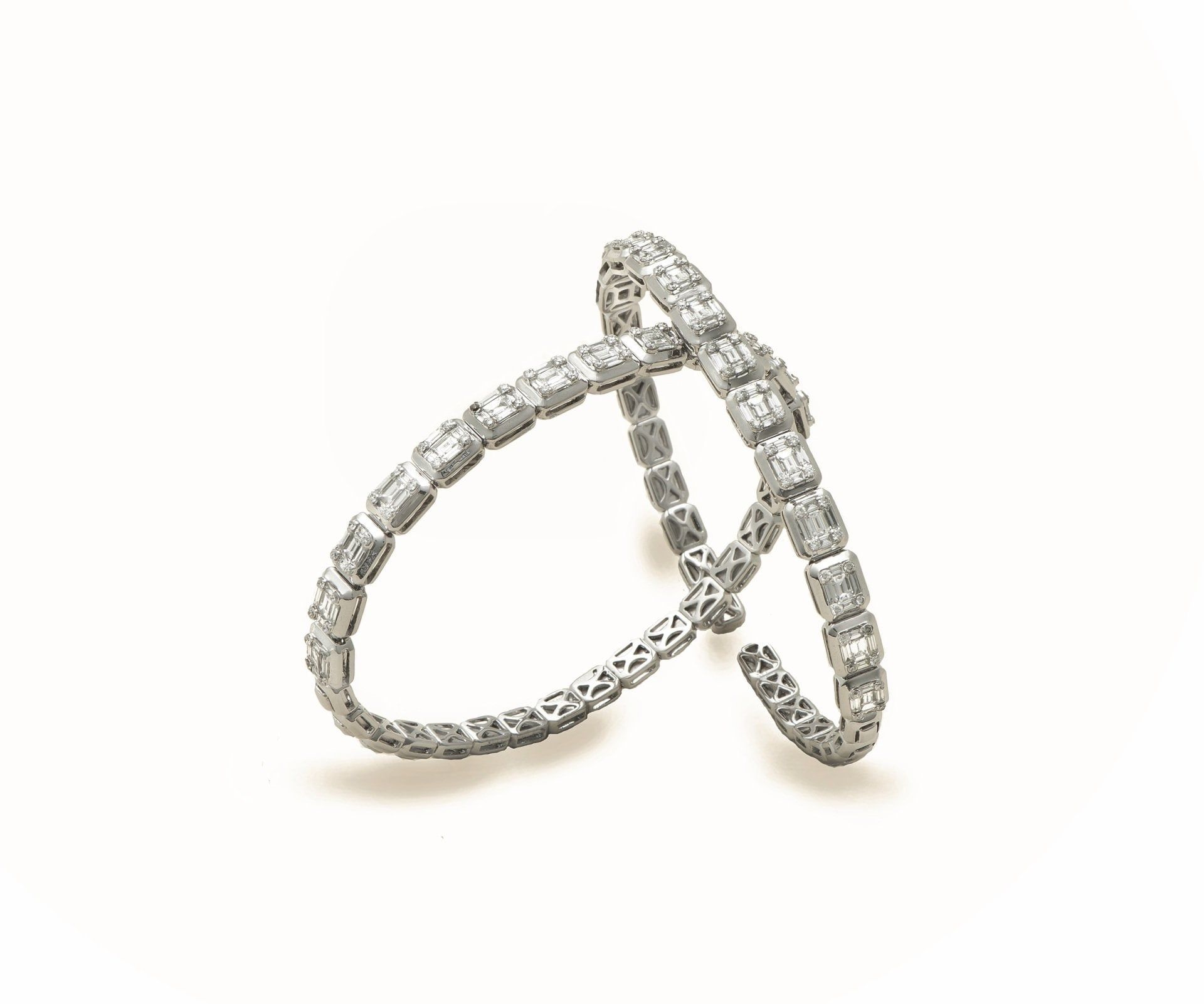 An open white gold bangle set with a line of diamonds