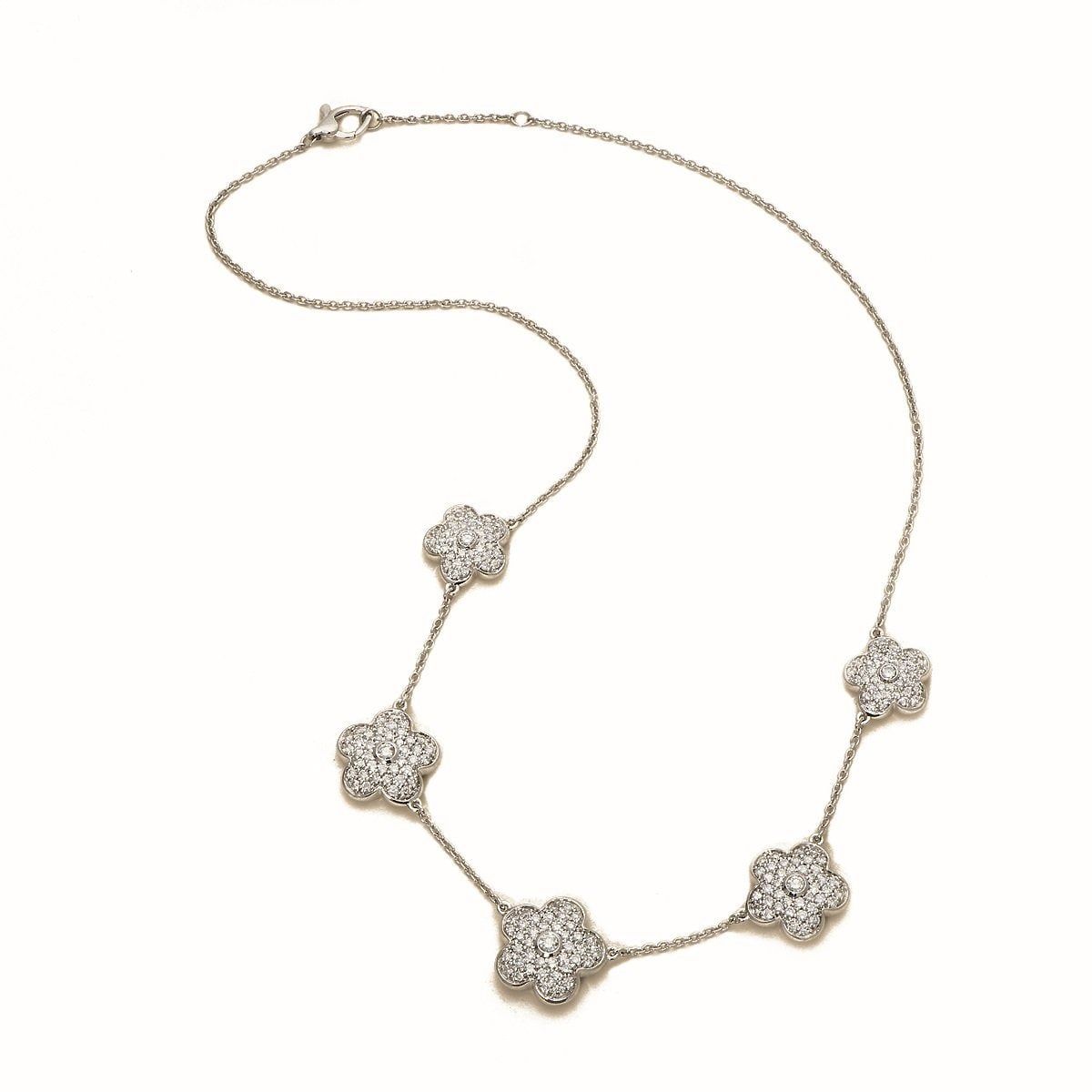 A gold station necklace set with pavé diamond quatrefoils