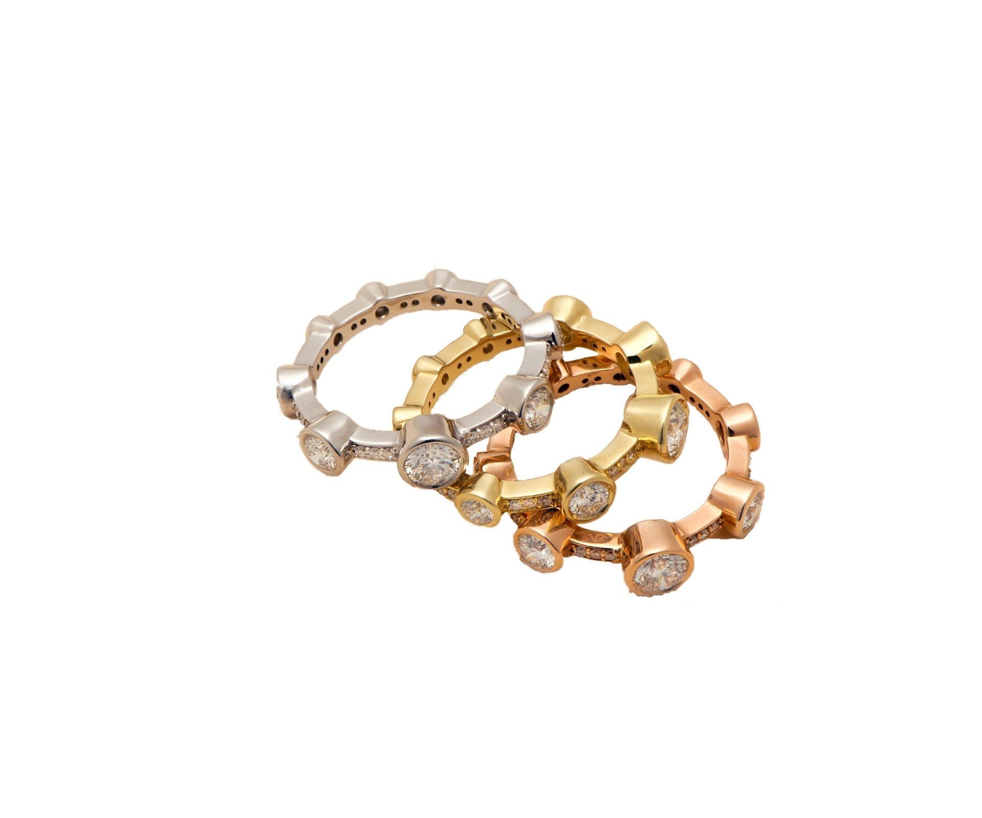 Three slim stacking bands in white, yellow and rose gold
