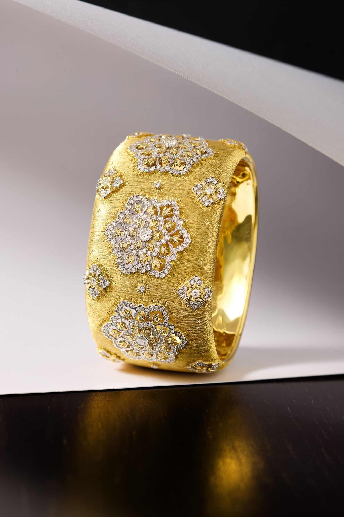 A diamond ring displayed on a pale green velvet cushion